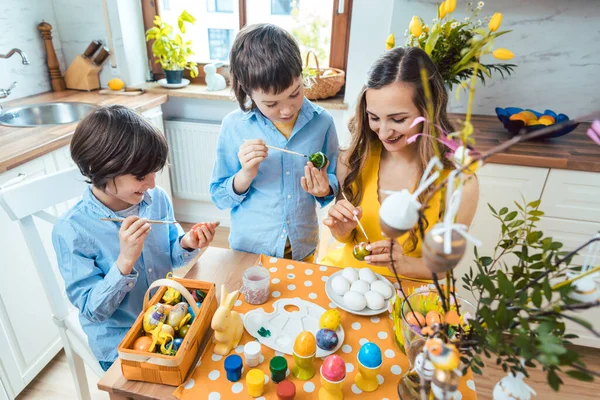 Μητέρα και γιοι χρωματίζουν τα αυγά για το Πάσχα — Φωτογραφία Αρχείου