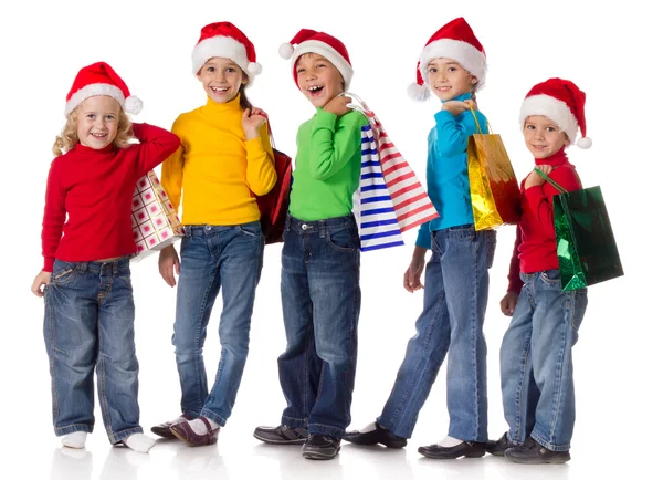 Gruppo di bambini felici con regali di Natale Foto Stock