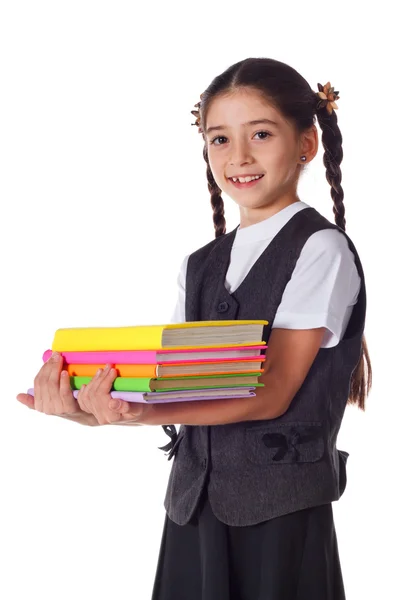 書籍のスタックと立っている笑顔の女の子 — ストック写真