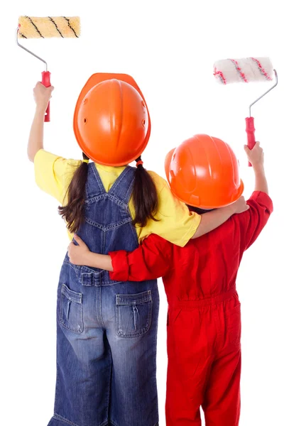 Two kids in coveralls with paint rollers — Stock Photo, Image