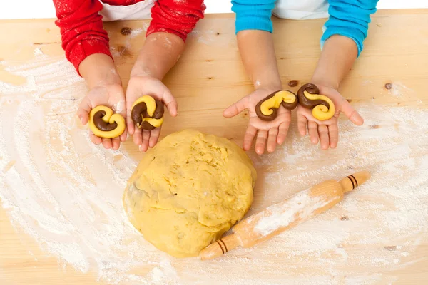 Child's hands with dough above the table — Stock Photo, Image