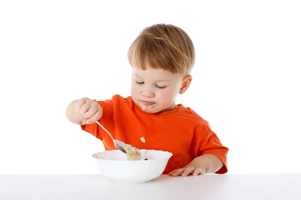 Little boy eating the oatmeal — Stock Photo, Image