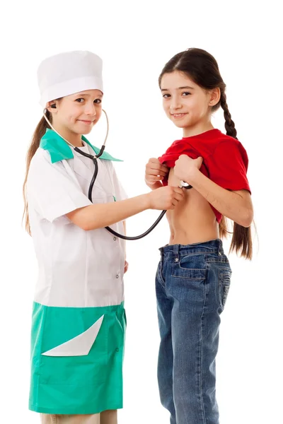 Kleines Mädchen als Arzt hört einem Mädchen zu — Stockfoto