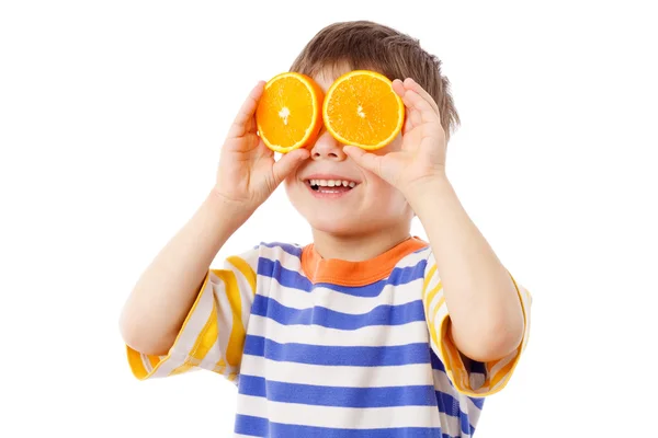 Garoto engraçado com frutas nos olhos — Fotografia de Stock