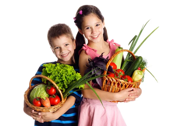 Bambini sorridenti con verdure nel cestino — Foto Stock