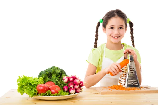 Girl grate the carrots — Stock Photo, Image