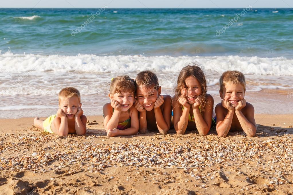 Five kids on the beach — Stock Photo © sbworld7 40309165