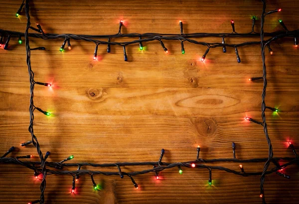 어두운 노란색의 축제용 배경에 램프의 프레임 크리스마스 — 스톡 사진