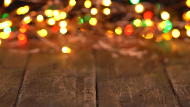 Wooden background with glowing electric garland — Stock Video