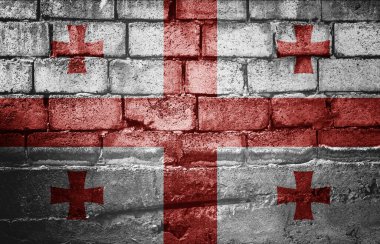 Üzerinde bayrak olan siyah tuğla duvar.