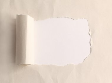 Brown package paper torn to reveal white panel ideal for copy space clipart