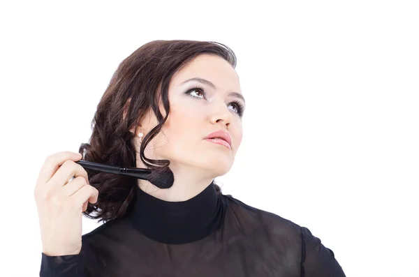 Beautiful woman with makeup brush near her face - isolated on wh — Stock Photo, Image