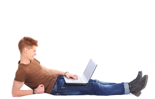 Successful happy man lying down o n floor using laptop — Stock Photo, Image