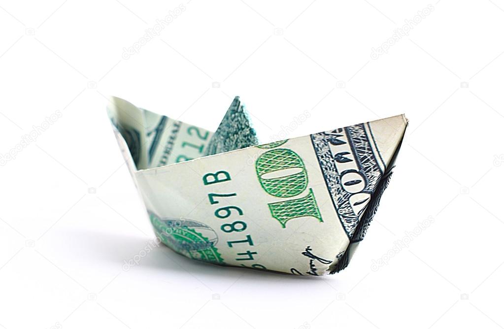 Hundred dollar banknote folded as a boat, finance concept.