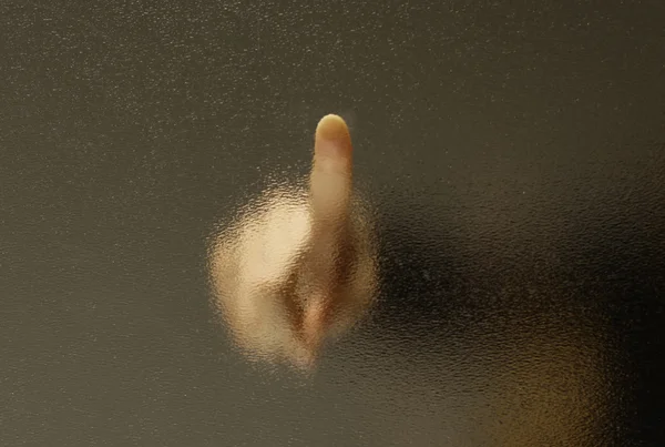 Touch a finger through the frosted glass. — Stock Photo, Image