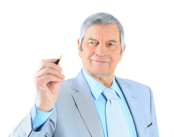 Businessman in age, writes in the air. Isolated on a white background. Royalty Free Stock Photos