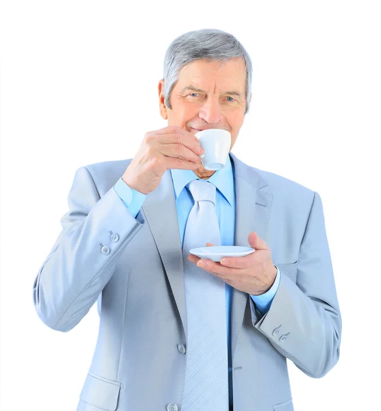 Businessman in age, drinking coffee. Isolated on a white background. — Stock Photo, Image