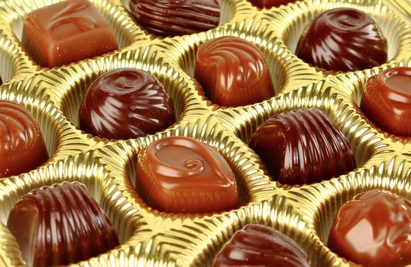 Closeup hnědá čokoláda cukroví pozadí — Stock fotografie