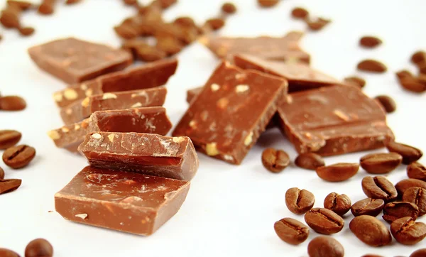 Süße Schokoladenbonbons und Kaffeebohnen isoliert auf weißem Hintergrund — Stockfoto