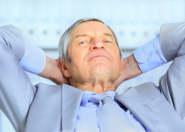 Businessman in age, resting for a break. Isolated on a white background. — Stock Photo, Image