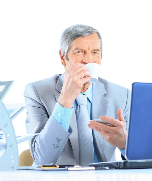 The businessman at the age of drinking coffee during the break. Isolated on a white background. — Stock Photo, Image