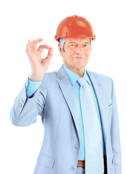 Engineer of age, shows that everything is OK. Isolated on a white background. Royalty Free Stock Images