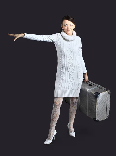 Beautiful girl in white, with a large suitcase. Isolated on a black background. — Stock Photo, Image