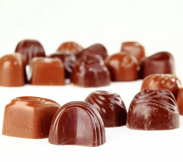 Primo piano marrone cioccolato caramelle sfondo — Foto Stock