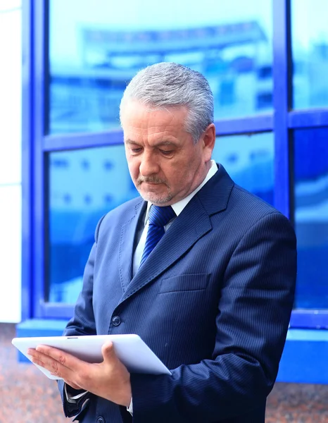 Handsome businessman using his digital tablet — Stock Photo, Image