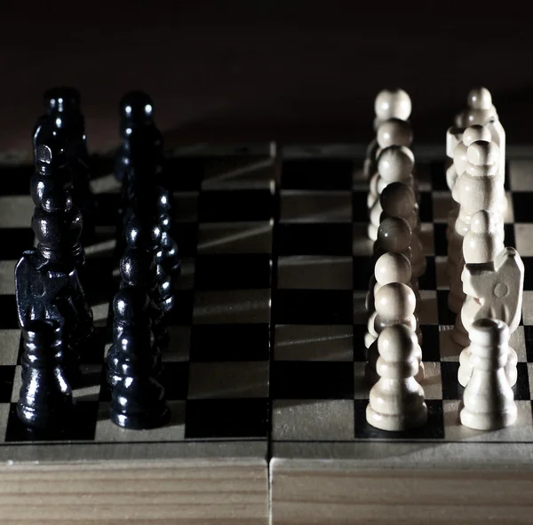 Composition with chessmen on glossy chessboard — Stock Photo, Image