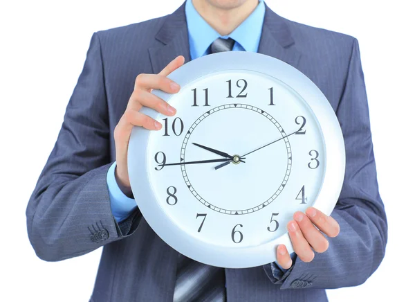 A young businessman with a wall clock. — Stock Photo, Image