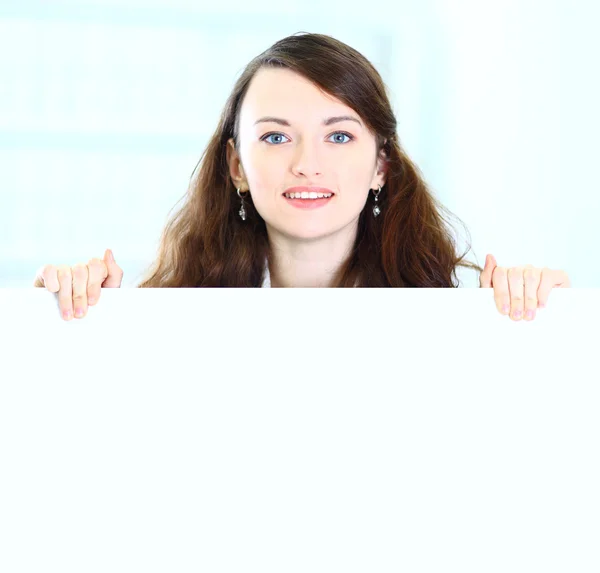 Beautiful businesswoman shows a forward index fingers in the office. — Stock Photo, Image