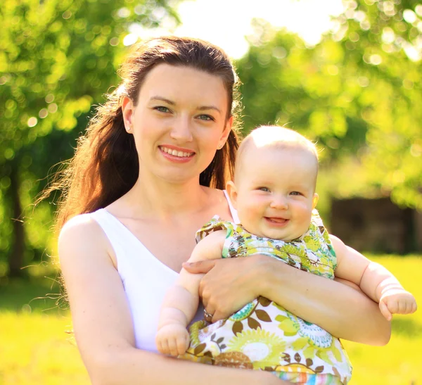 Mooie moeder en baby buitenshuis. aard. schoonheid moeder en haar kind samenspelen in park — Stockfoto