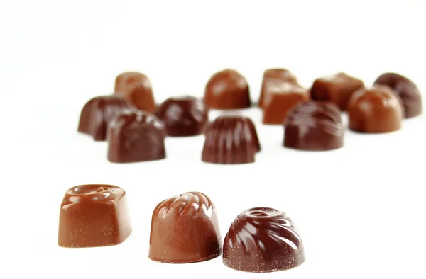 Primo piano marrone cioccolato caramelle sfondo — Foto Stock