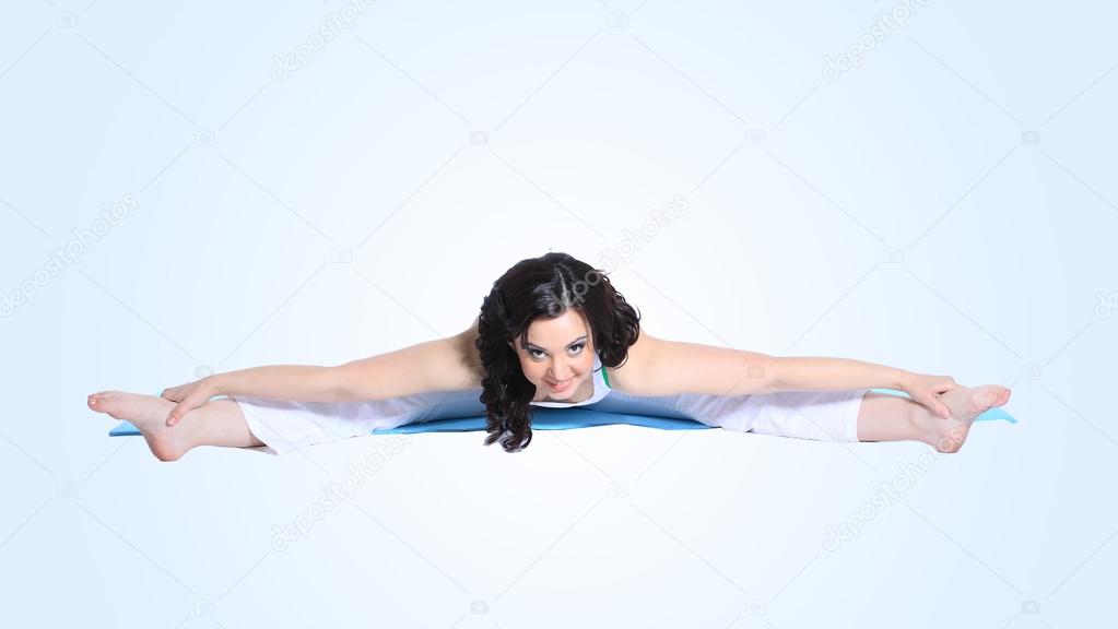 Young woman in yoga pose on isolated white background