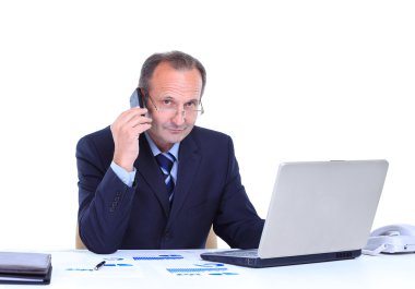 gülümseyen iş portresi adam cep telefonuyla konuşan ve bir dizüstü bilgisayarda ofiste çalışan