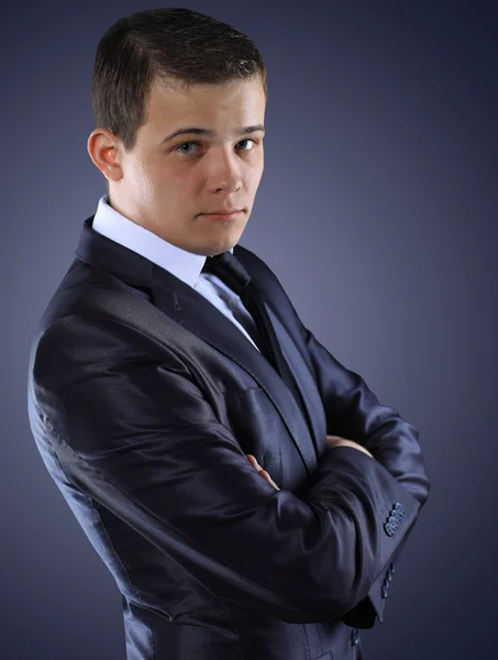 Portrait of young business man isolated over dark background — Stock Photo, Image