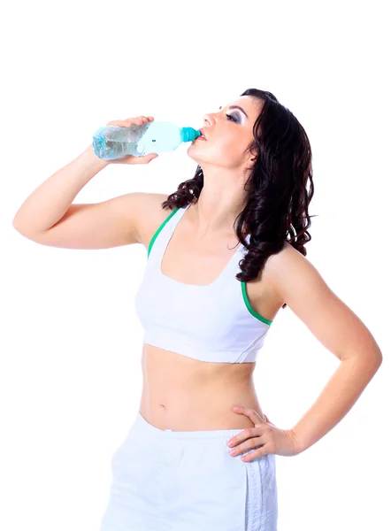 Jonge gelukkig lachende vrouw in sportkleding drinkwater, geïsoleerd op witte achtergrond — Stockfoto