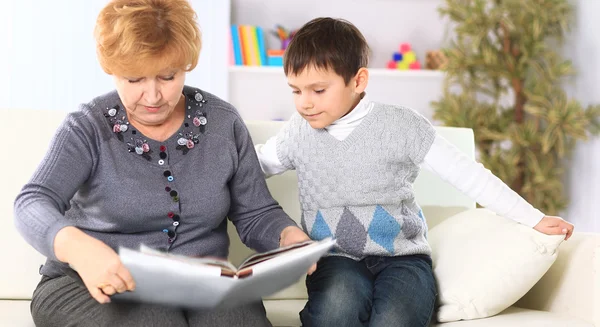 Grandmother and grandson reading a book — Stock Photo, Image