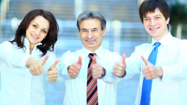 Three business partners keeping thumbs up — Stock Photo, Image