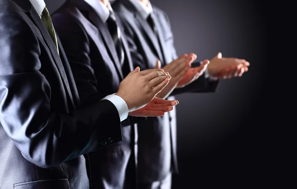 Male hands clapping on black, side-view — Stock Photo, Image