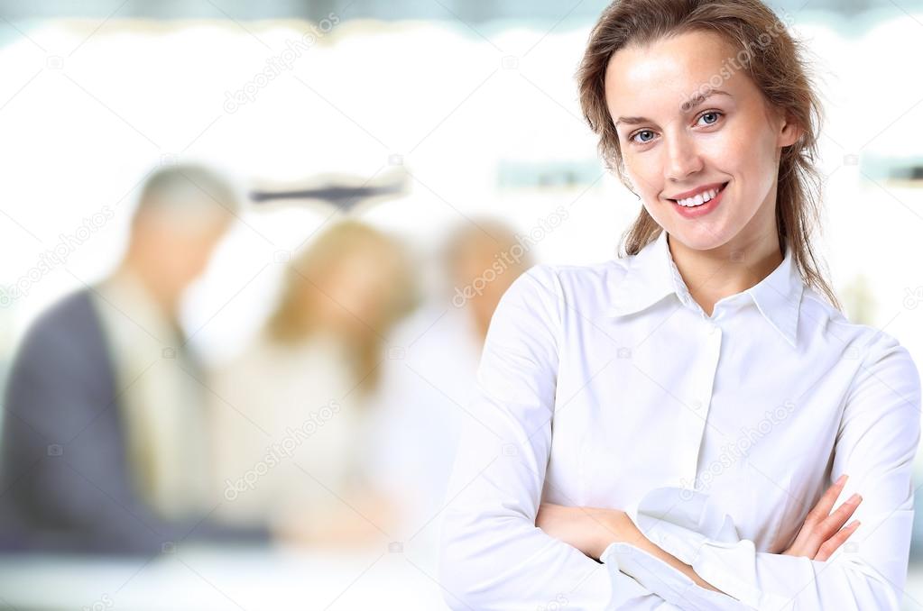 Business lady with positive look and cheerful smile posing for the camera
