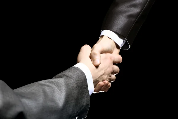 Close-up of business people shaking hands to confirm their partnership — Stock Photo, Image