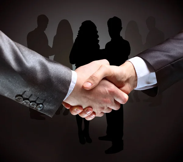 Close-up of business people shaking hands to confirm their partnership — Stock Photo, Image