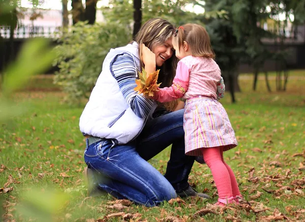 Smiling mother and little daughter on nature. Happy people outdoors — Stock Photo, Image