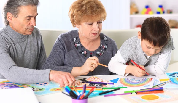 Grandmother, grandfather and grandson spend time together. Symbol of the family. — Stock Photo, Image