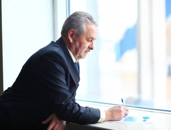 Handsome businessman using tablet computer in modern office — Stock Photo, Image