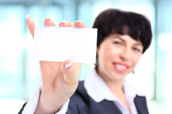 Business woman in her 40s holding business card — Stock Photo, Image