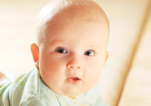 A cute baby girl in fairy wings laughs while looking up at the camera. — Stock Photo, Image