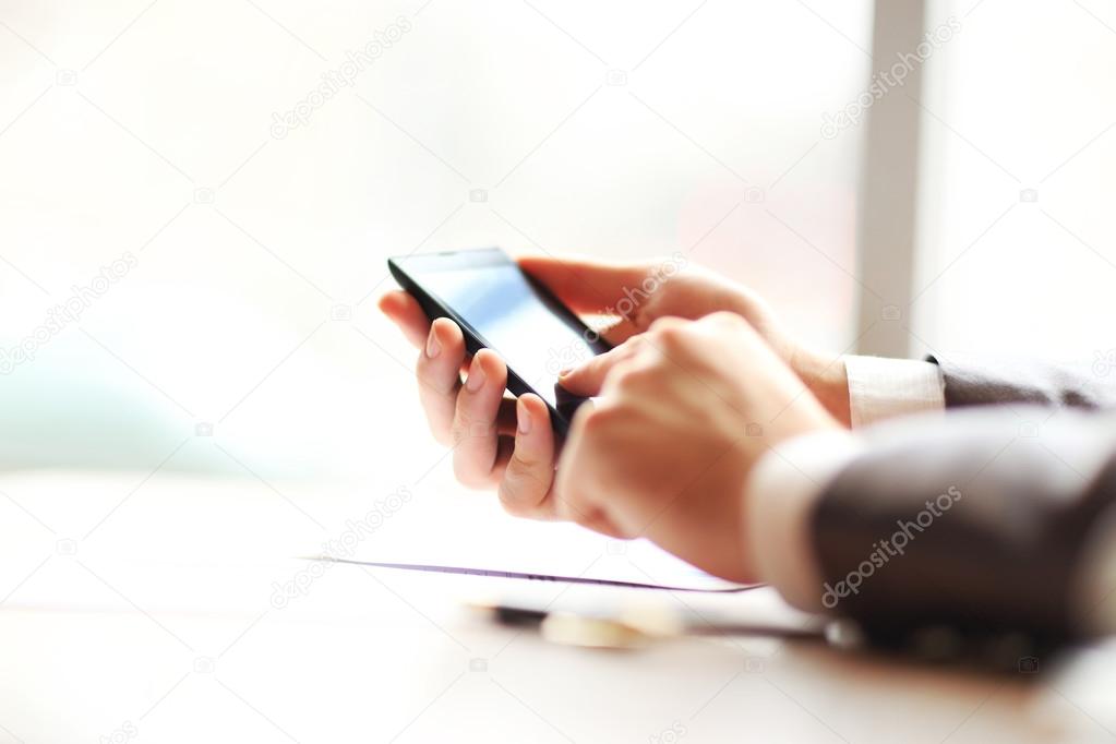 Young businessman working with modern devices, mobile phone.